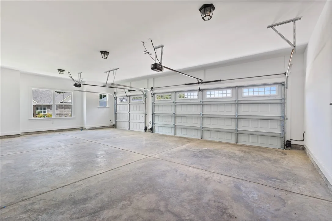 Three car garage has plenty of room for two cars and a golf cart or just a whole lot of storage.