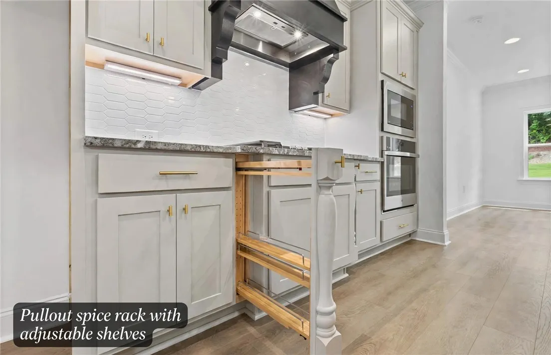 Pull out spice racks flank both sides of the cooktop.