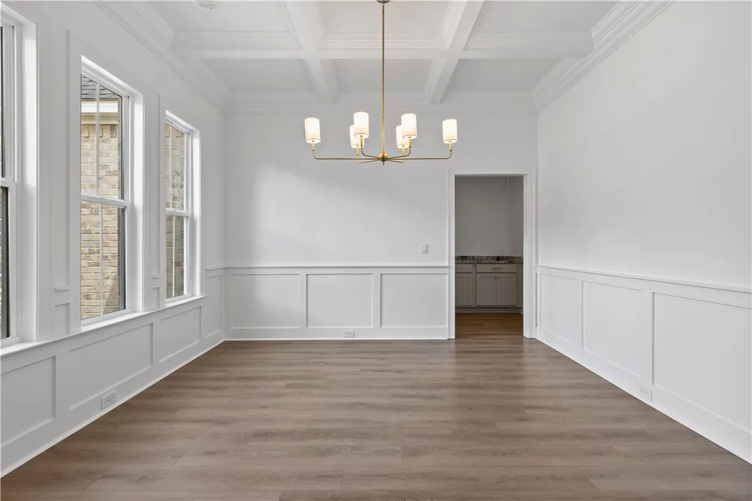 Elegant wainscoting and a classic coffered ceiling define this formal dining room.