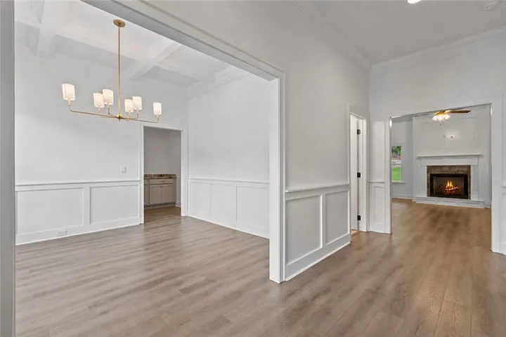 Elegant wainscoting and classic crown molding accent the entryway as you enter through the double doors.  The dining room is on your left as you enter with a half bath beyond that.
