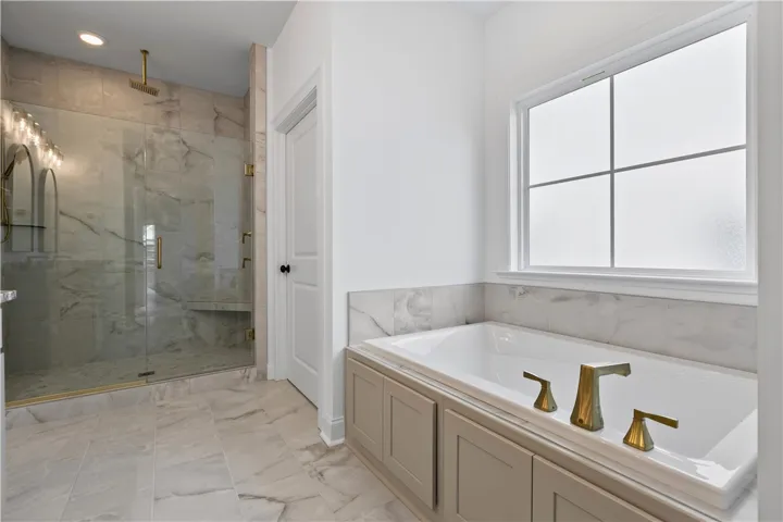The frosted window over the tub lets in natural light.