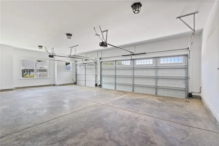 Three car garage has plenty of room for two cars and a golf cart or just a whole lot of storage.