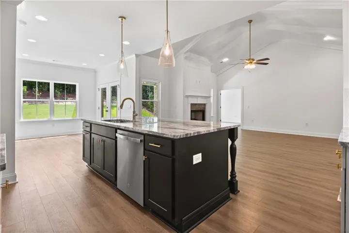 The kitchen island features a double trashcan drawer and plenty of storage on both sides.