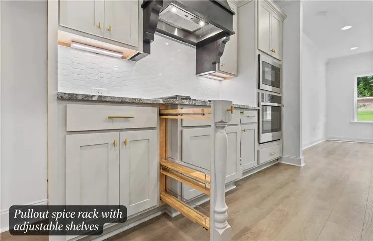 Pull out spice racks flank both sides of the cooktop.