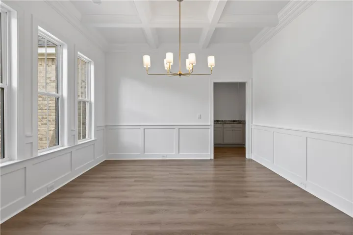 Elegant wainscoting and a classic coffered ceiling define this formal dining room.