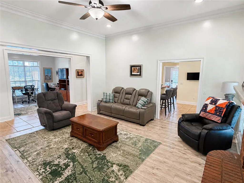An open doorway connects the airy living room to adjacent functional spaces.