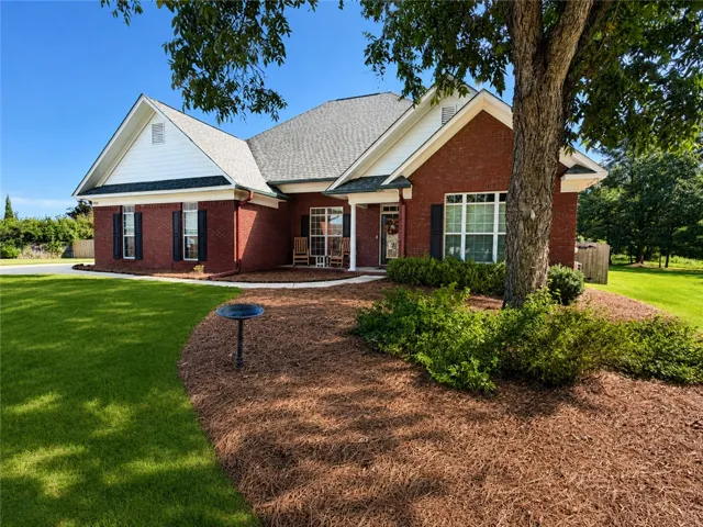 Classic brick craftsmanship defines this multi-gabled home framed by manicured landscaping.