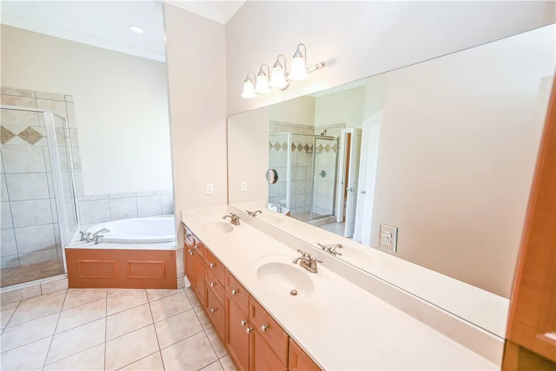 Moving to the primary bathroom, there's plenty of counter and mirror space to go around.