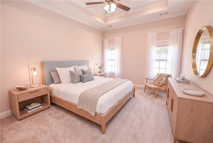 DIGITALLY STAGED Primary bedroom
One side of the house is home to the primary suite, with trey ceilings and large windows!