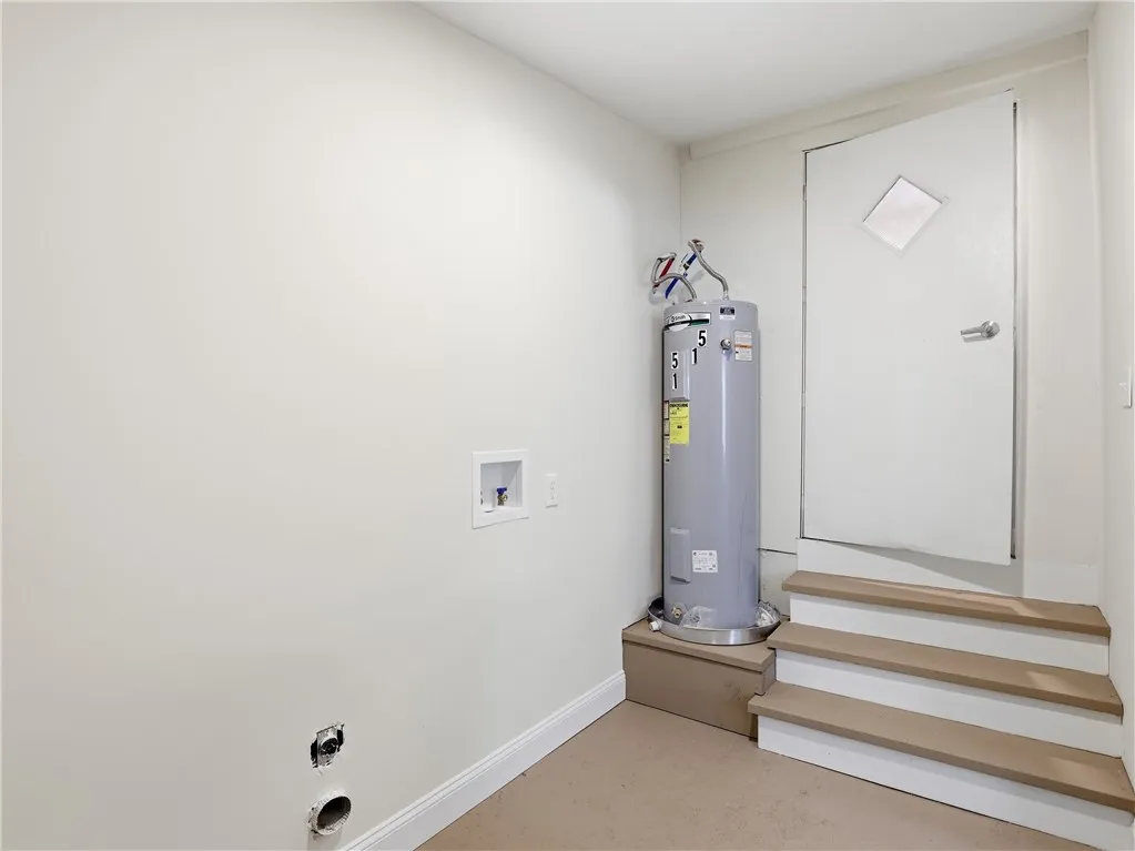 Laundry room with guest bedroom that offers access to the backyard.