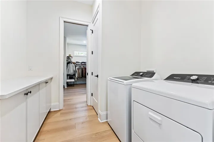 Laundry room walk through to owner's closet
