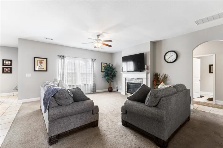 An inviting  fireplace serves as the centerpiece of this comfortable living space.