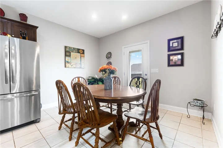 Tiled flooring and smooth neutral walls define this inviting dining area adjacent to the kitchen.