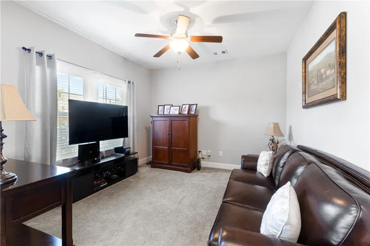 Soft wall-to-wall carpeting and classic crown molding define this versatile living space.