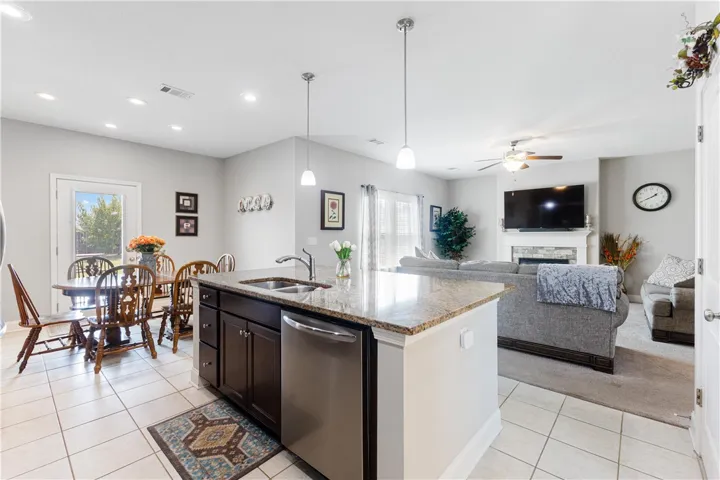 An open floor plan connects the kitchen island to a dining area and living room.
