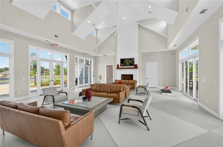 This bright gathering space features soaring ceilings, a fireplace, and an abundance of natural light.