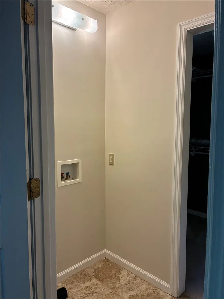 closet in primary room accommodates stackable washer/dryer