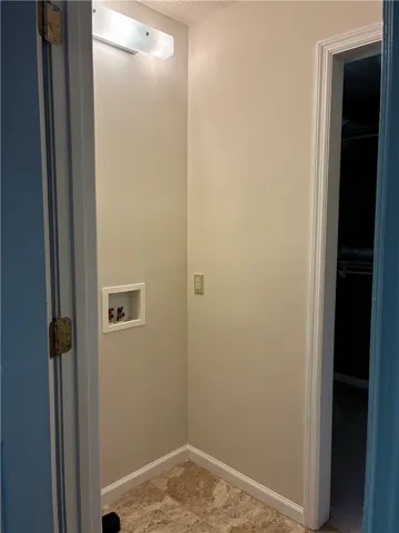 closet in primary room accommodates stackable washer/dryer