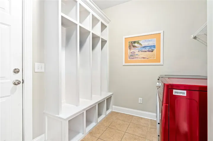 Laundry room with built ins and broom closet