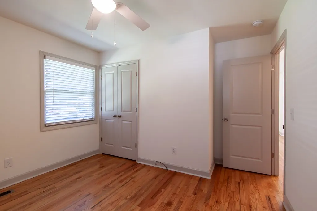 Polished hardwood floors and generous natural light define this versatile secondary bedroom space.