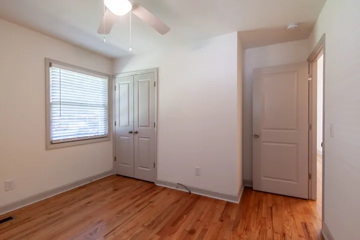 Polished hardwood floors and generous natural light define this versatile secondary bedroom space.