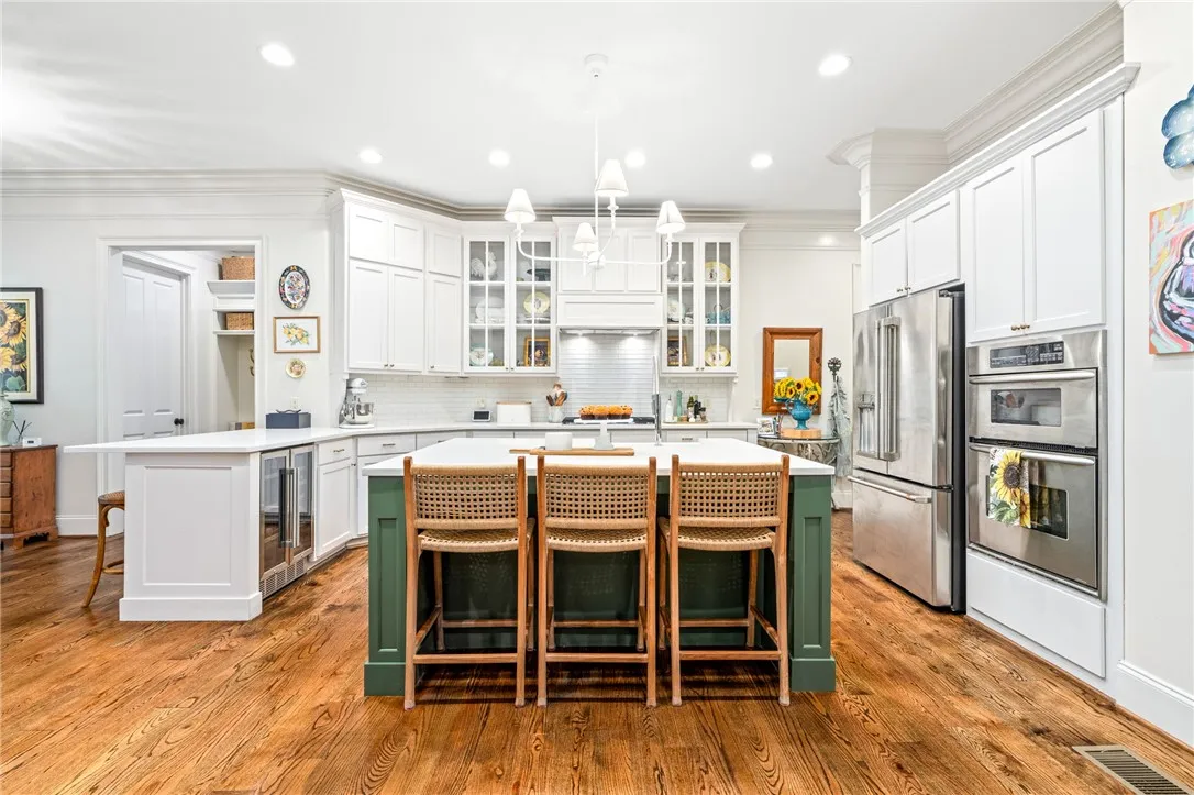 Custom cabinetry and expansive central island are found in this gourmet kitchen.