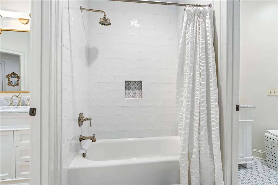 Crisp subway tile surrounds a classic tub and shower combination.