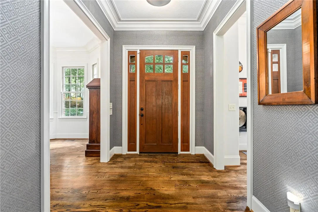 Rich hardwood floors and beautiful crown molding create an inviting first impression in this entryway.