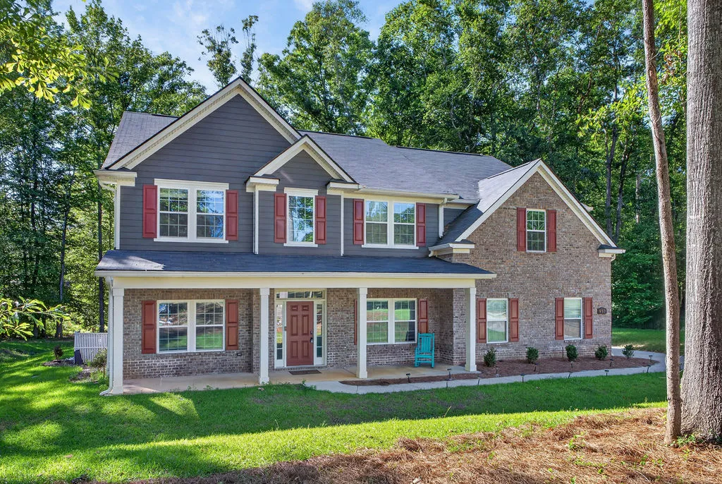 A classic facade of brick and siding provides a welcoming entry with ample porch space.