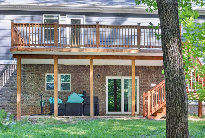 A elevated deck and a ground-level patio provide ample outdoor living space.