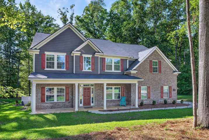 A classic facade of brick and siding provides a welcoming entry with ample porch space.