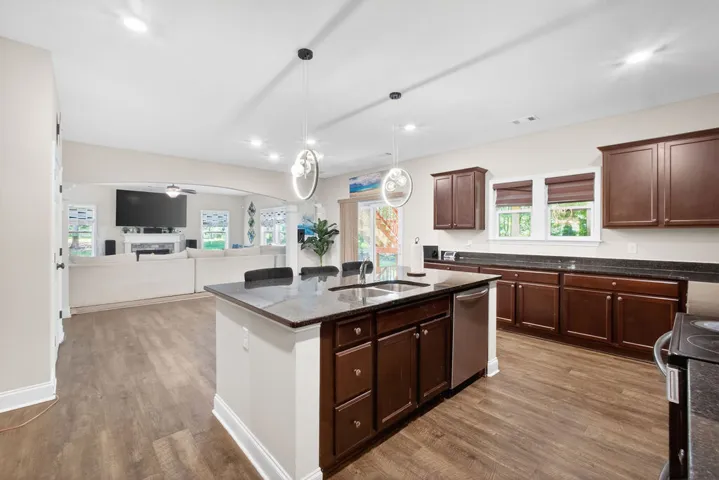 An open-concept design connects the kitchen's island and ample cabinetry to the living space.