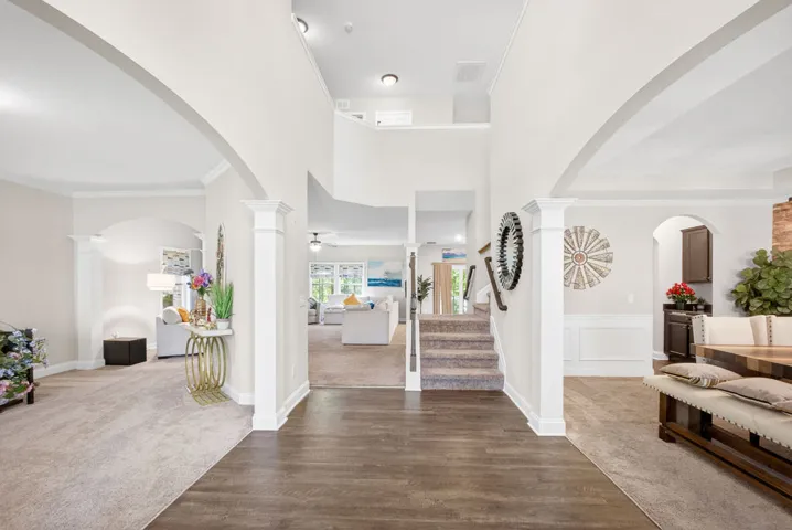 Enter into a bright, two-story foyer with hardwood floors and an inviting view into the living areas.