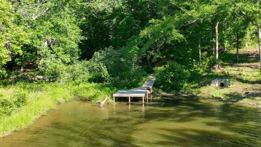 A tranquil waterfront setting with a private boat dock offers direct access to serene waters.