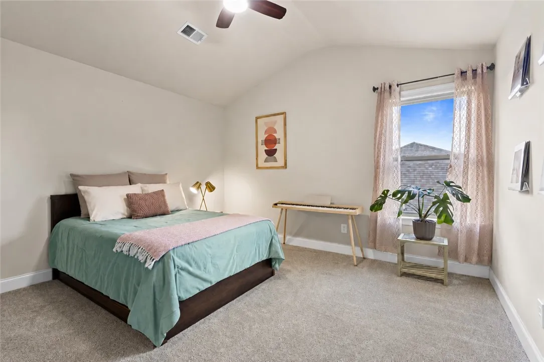 Another upstairs bedroom offers generous floor space, a vaulted ceiling and a large window - making it a comfortable guest room, bedroom or flex space to make your own.