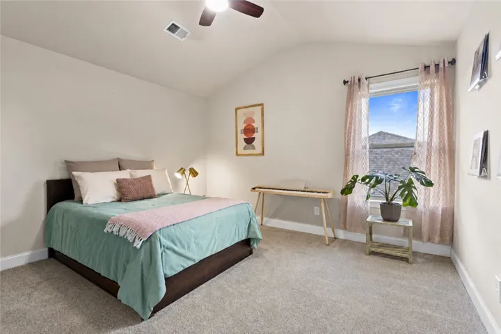 Another upstairs bedroom offers generous floor space, a vaulted ceiling and a large window - making it a comfortable guest room, bedroom or flex space to make your own.