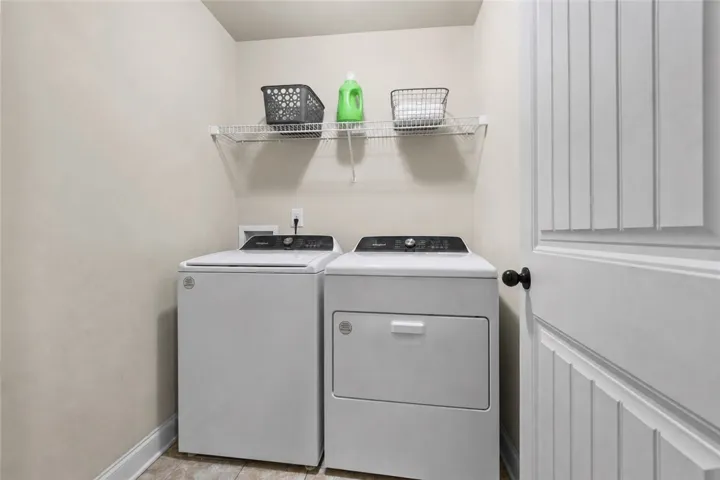 The upstairs laundry room keeps the everyday chores conveniently close to the bedrooms.  Washer and dryer convey with the house.