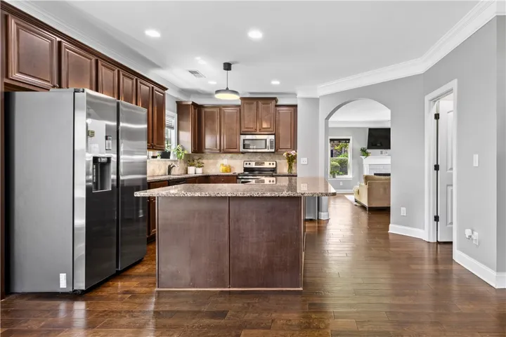 A large pantry is located just across from the island, adding even more practical storage in the kitchen.