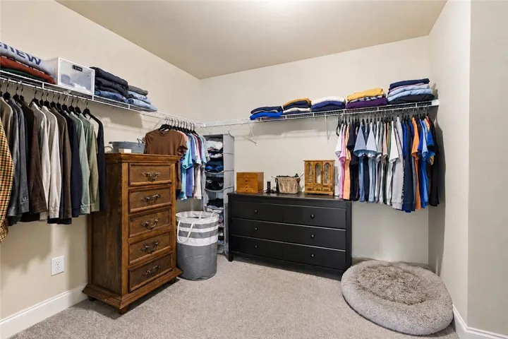 The main closet is generously sized with plenty of room for hanging clothes, dressers and shelving.