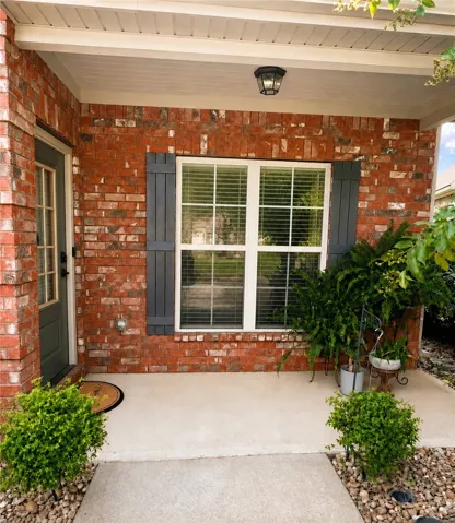 The covered front porch creates a warm welcome, with a sheltered entry and room to add a favorite chair or seasonal touches.