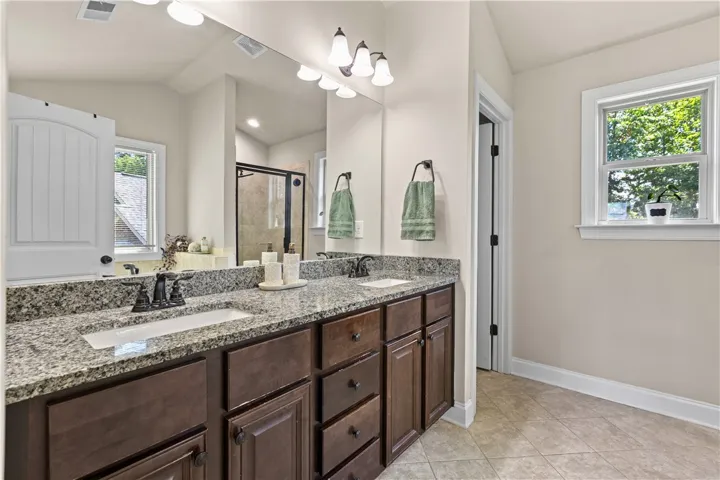 The en-suite bath has a double vanity and separate water closet.