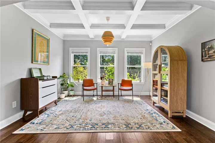 Designed as a dining room but currently enjoyed as a sitting room, this versatile space can easily adapt for whichever you need -with a beautiful coffered ceiling and new light fixture.