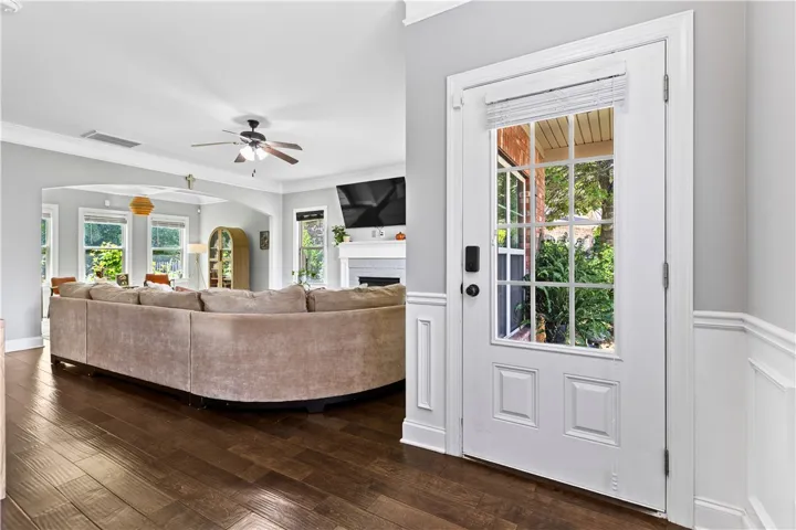 A welcoming entry opens to a bright, inviting interior, where rich floors, crisp trim, and an easy flow into the main living space set the tone for the home.