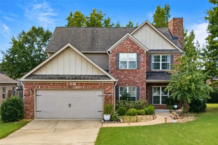 Beautiful curb appeal welcomes you to Chesham Drive, with timeless brick, mature landscaping and an inviting covered entry.