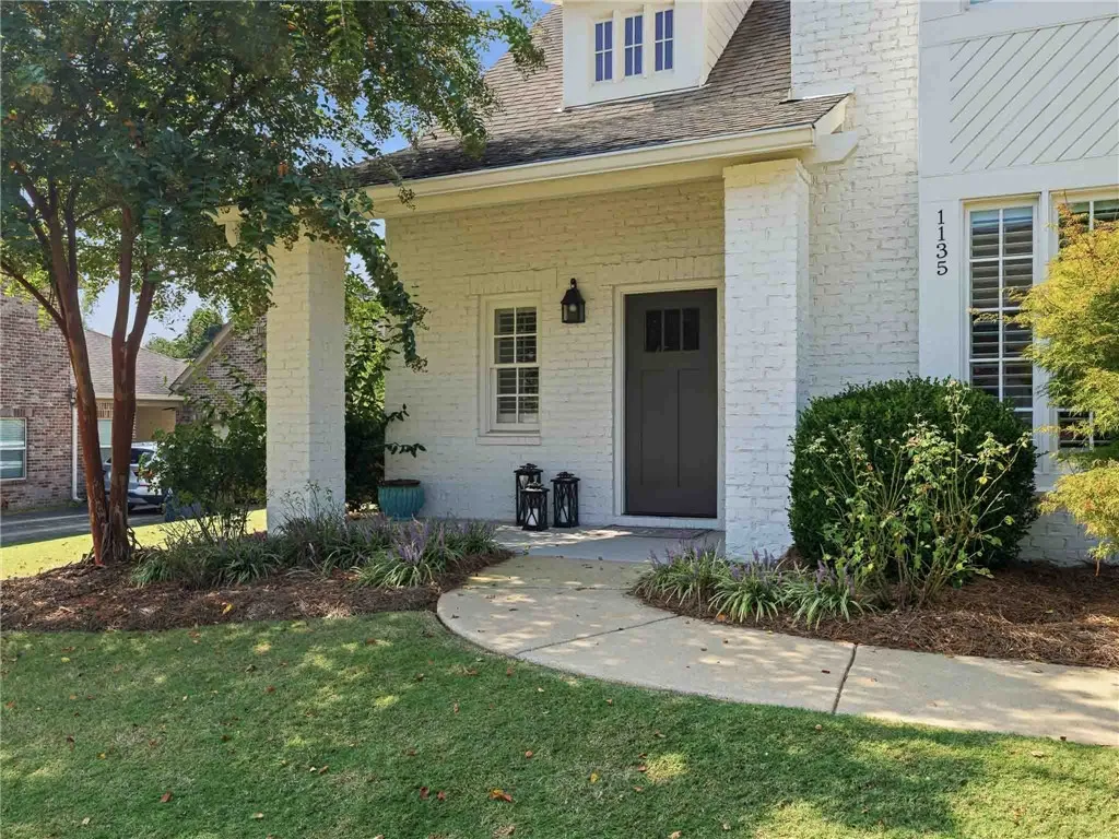 A walkway from the drive to the covered front porch offers a friendly, welcoming approach to the home.