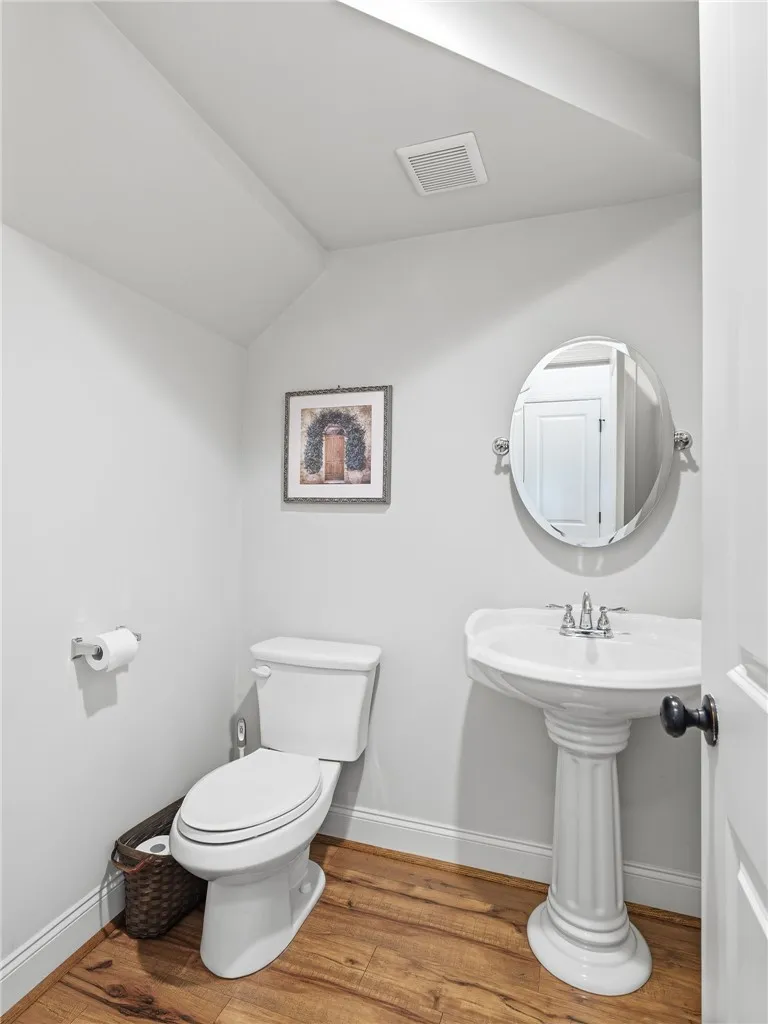 A powder room is conveniently located near the common areas.