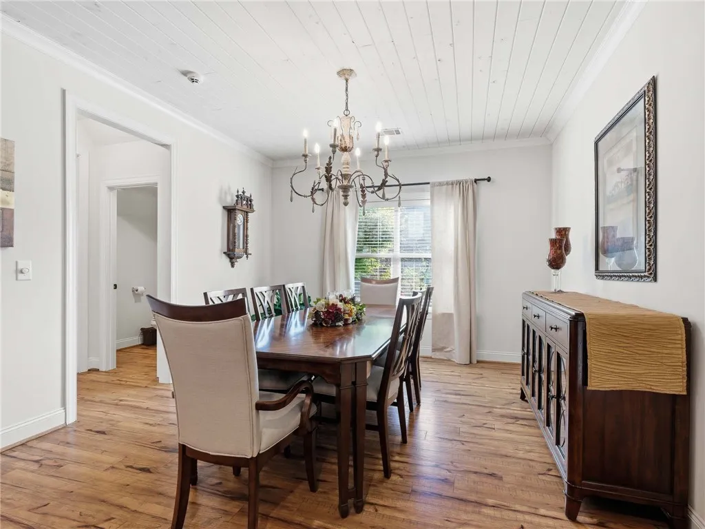 The dining room accommodates a large table and additional furniture.