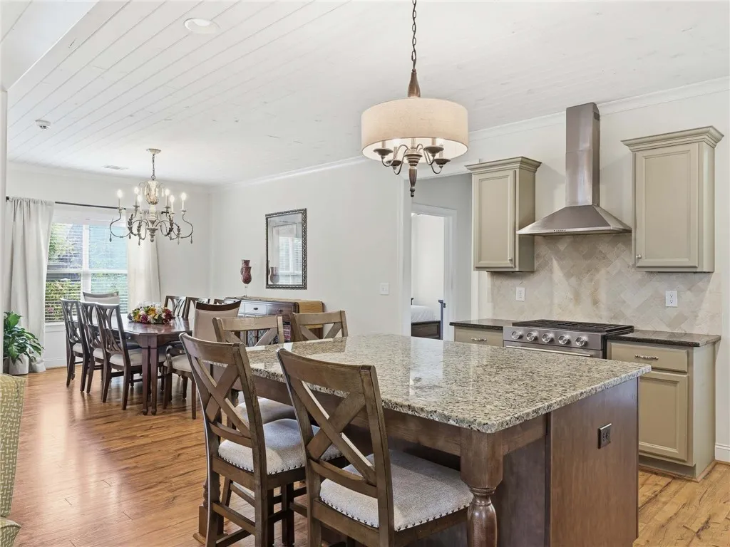 With bar seating and an adjacent dining room, the home offers multiple places to gather for meals.