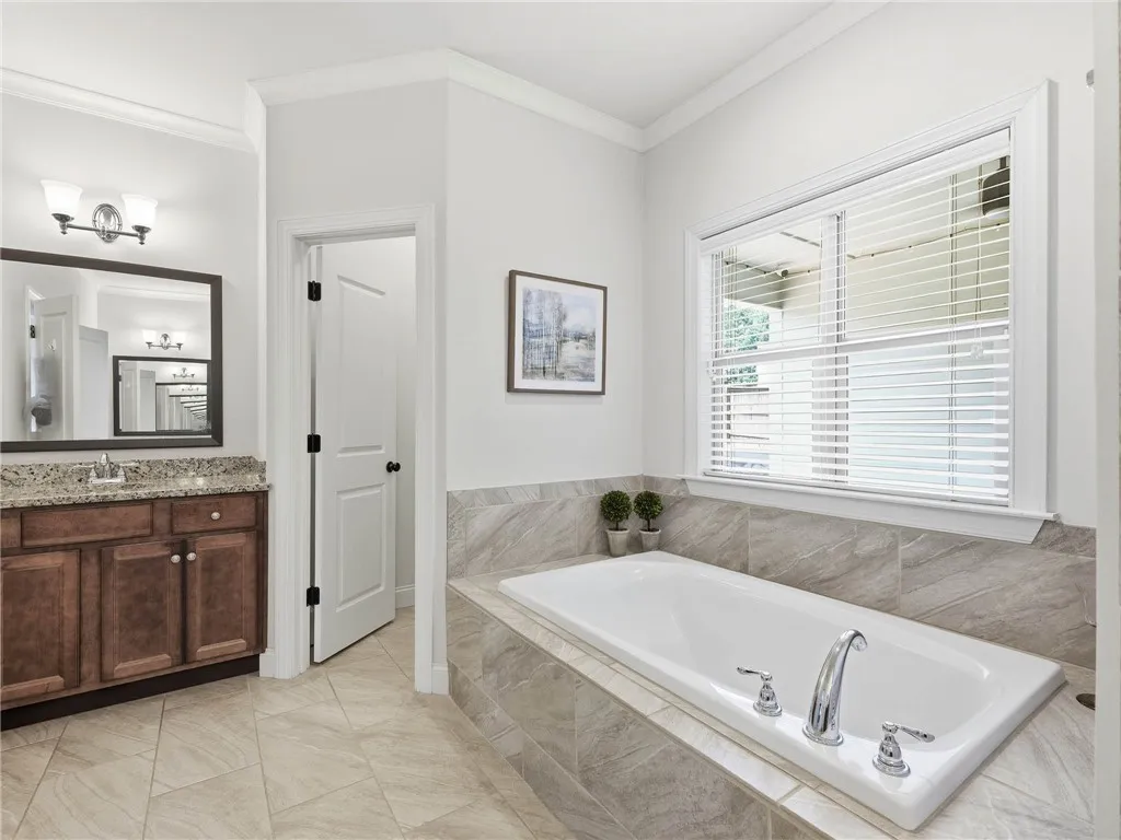 The breezeway-facing window invites natural light into the room while preserving a sense of privacy.