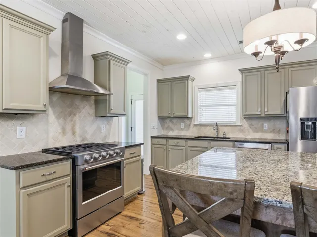Modern stainless KitchenAid appliances pair beautifully with the home’s warm, traditional finishes.